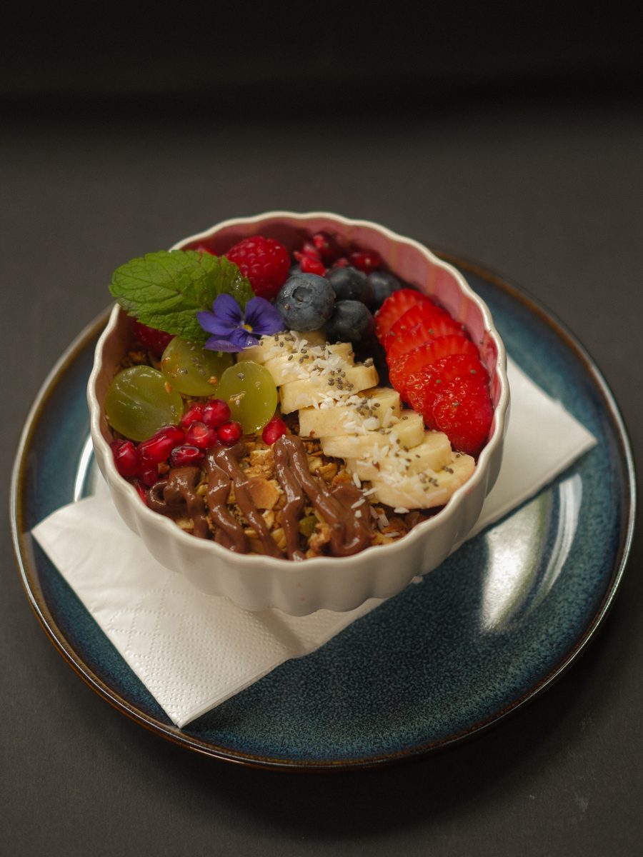 Acai bowl topped with fresh berries, banana and homemade granola