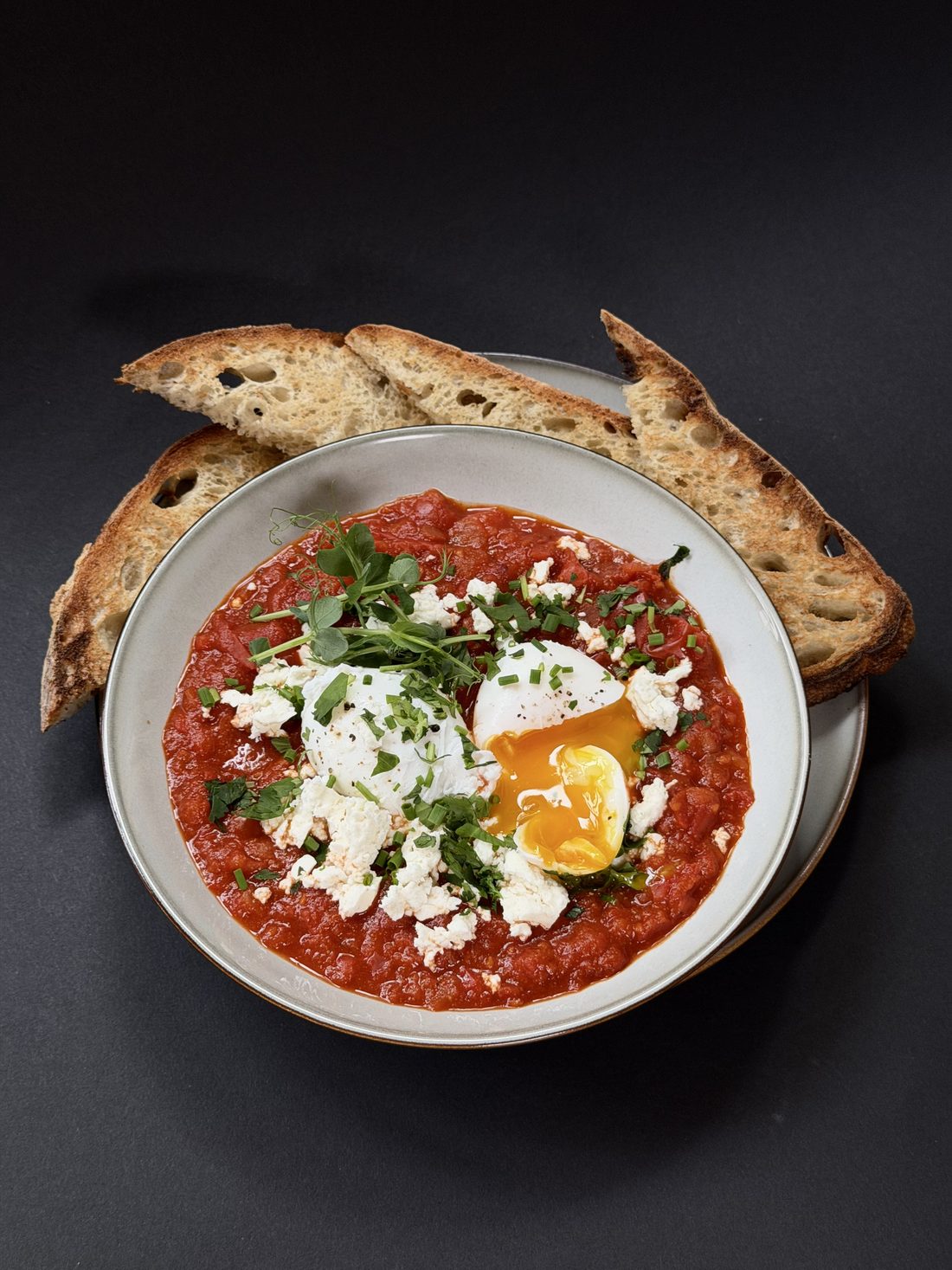 Shakshuka with poached eggs, feta and toasted sourdough